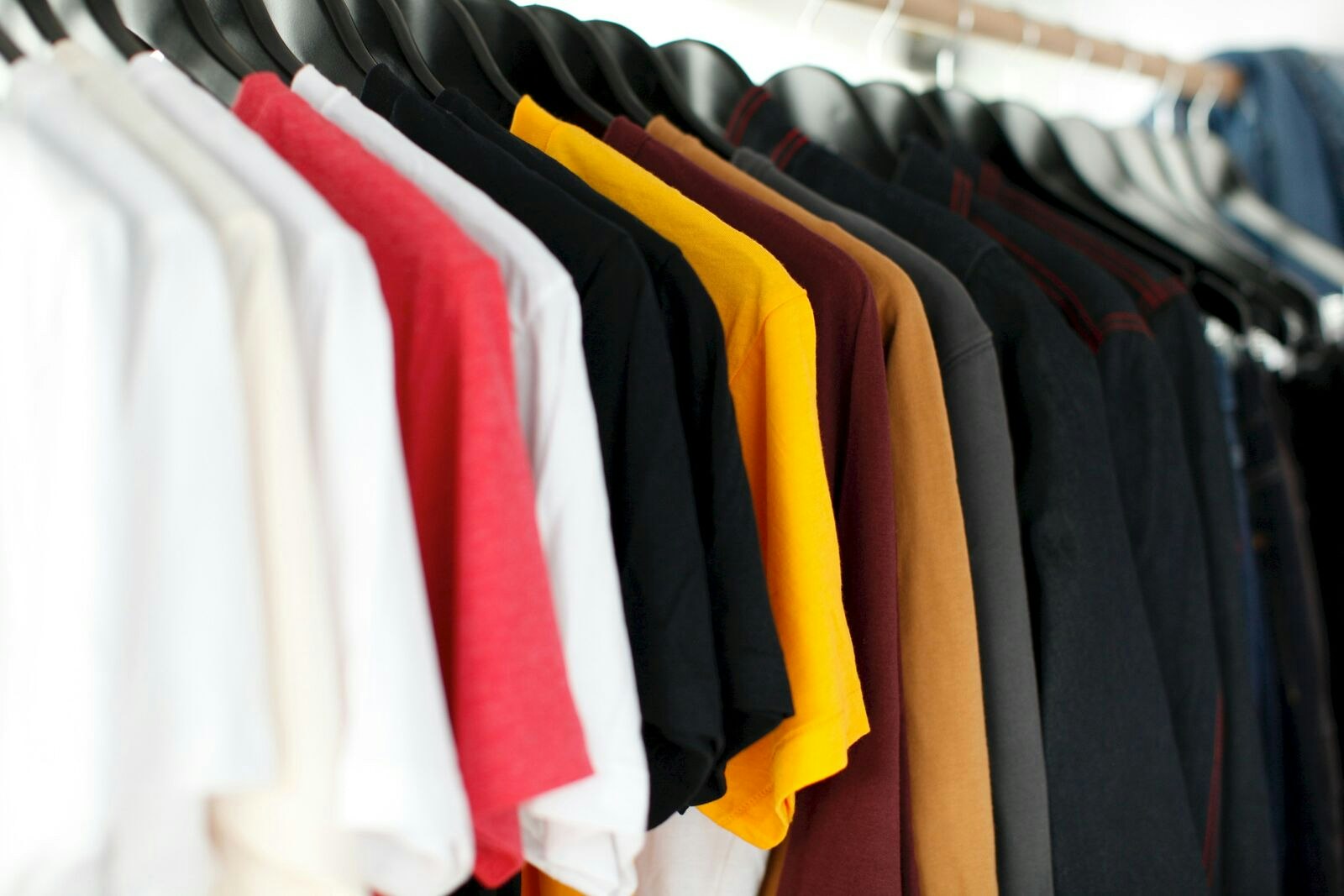 Clothes Hanging on a Rack in a Store