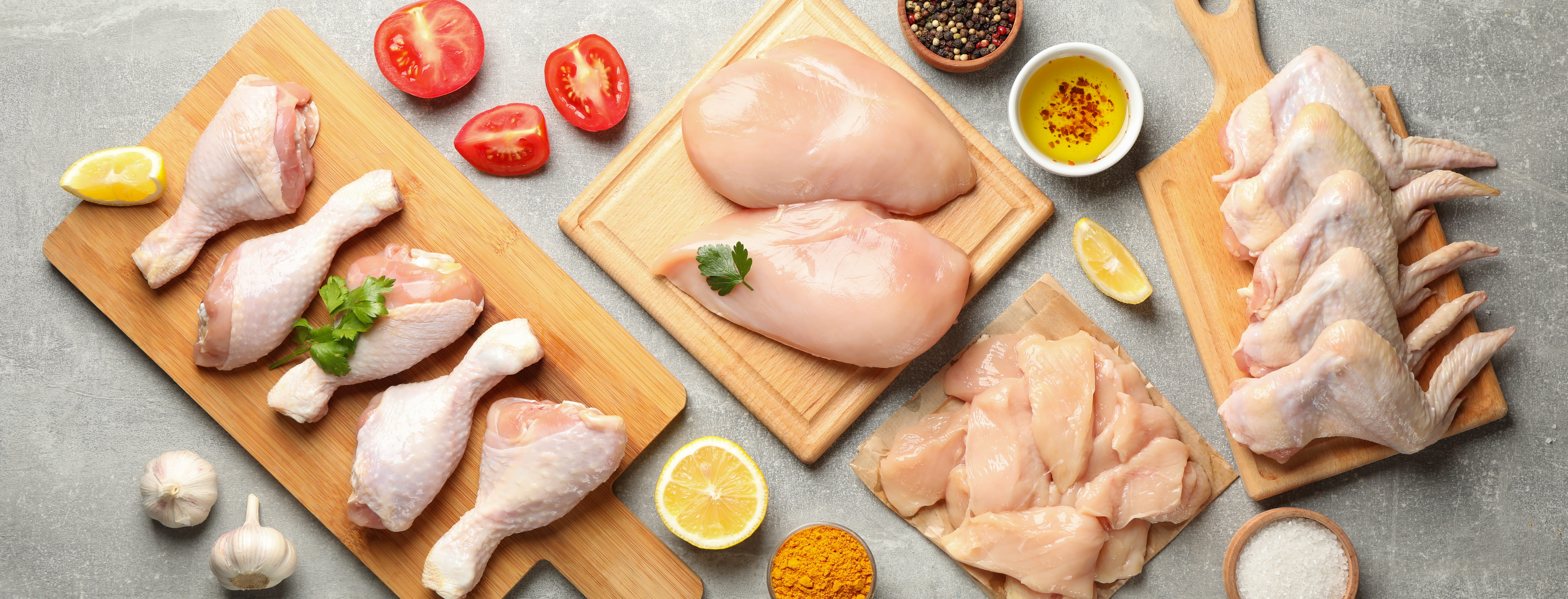 Composition with raw chicken meat on gray background