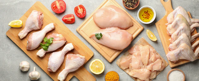 Composition with raw chicken meat on gray background
