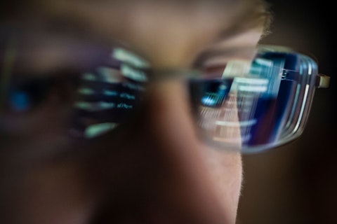 Computer Screen Reflecting in Man's Glasses