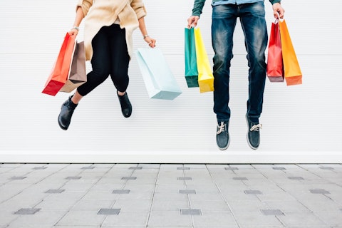 Couple Jumping with Shopping Bags