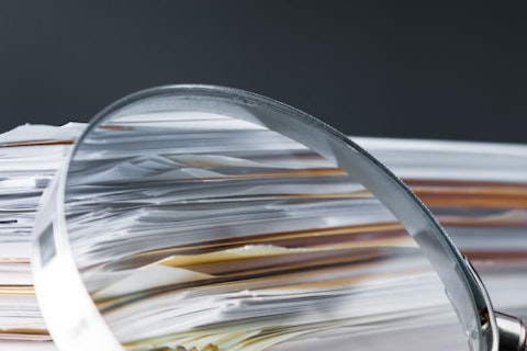Documents on a Desk and Magnifying Glass