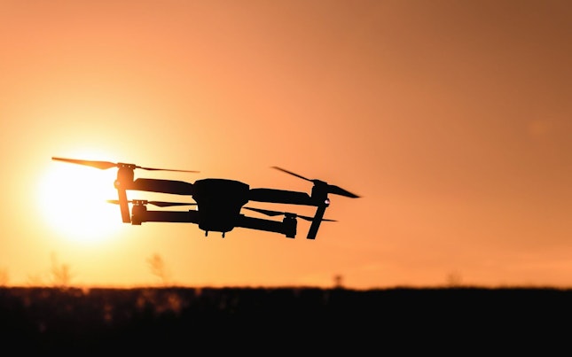 Drone Flying Against Sunset