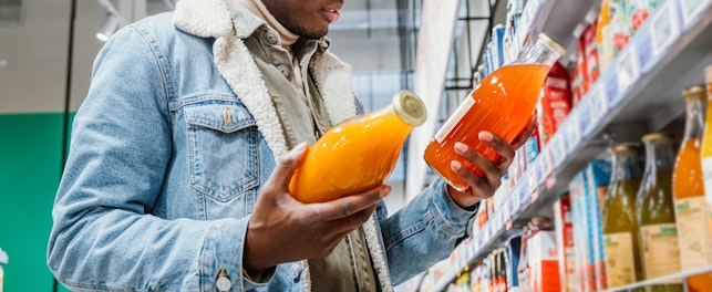 Man choosing juice in a supermarket