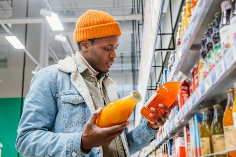 Man choosing juice in a supermarket