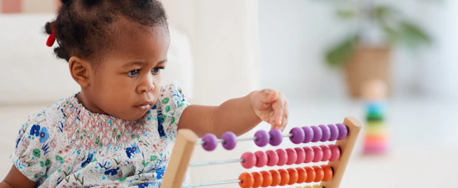 Girl Playing Colorful Abacus Toy