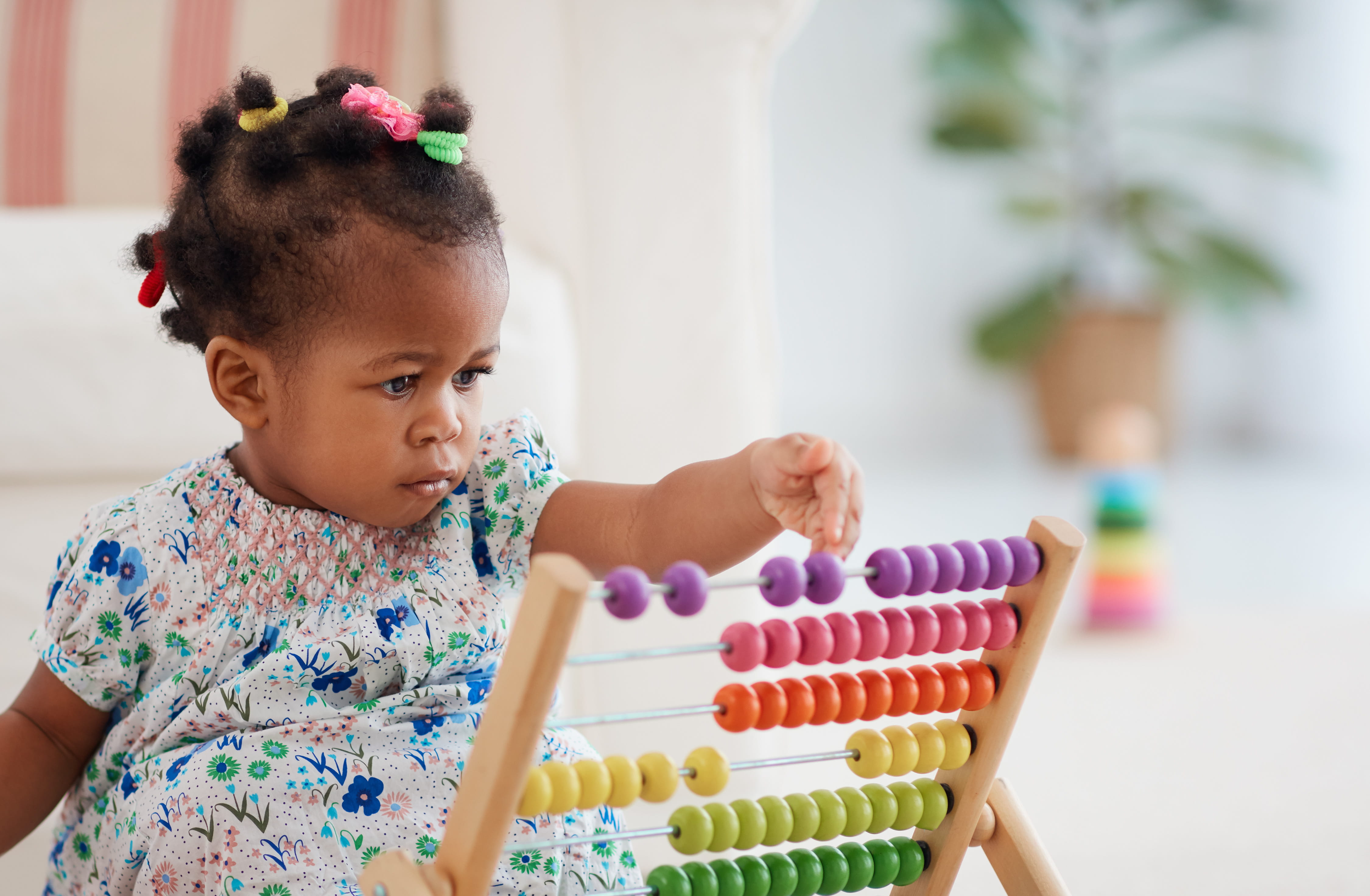 Girl Playing Colorful Abacus Toy