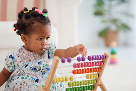 Girl Playing Colorful Abacus Toy