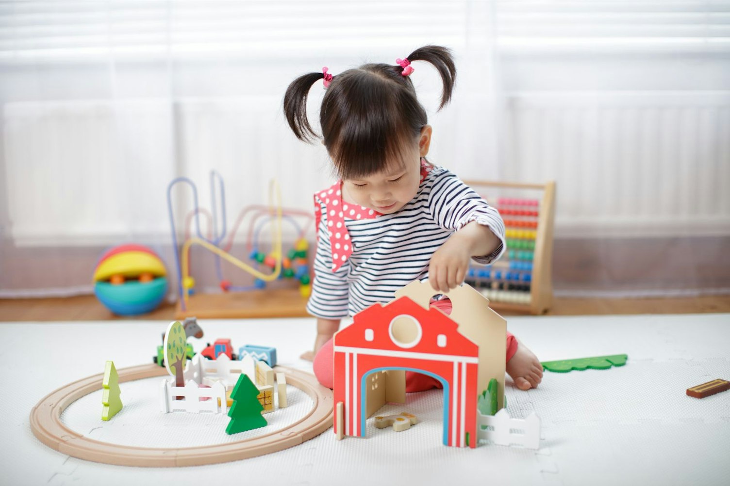 Girl playing with wooden toys