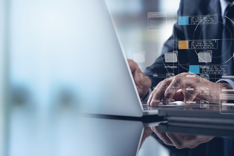 Hands typing on a laptop with transparent digital interface graphics overlaid, representing data management, information systems, or advanced digital workflows.
