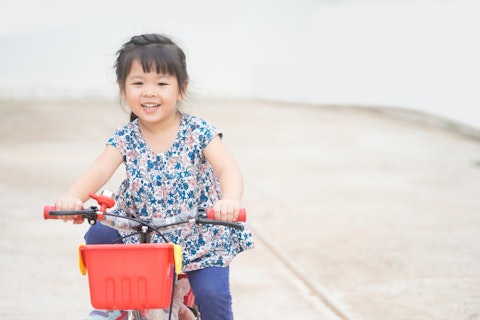 Happy Little Asian Girl on a Bicycle