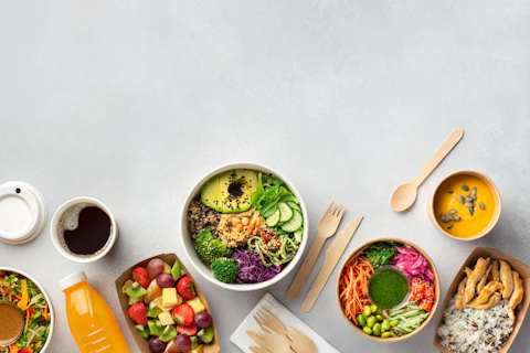 Healthy take away food and drinks in disposable eco friendly paper containers on gray background