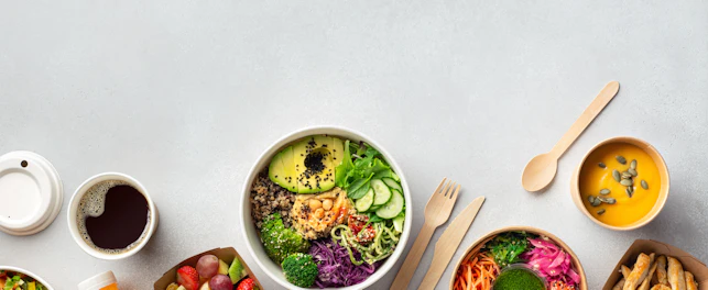 Healthy take away food and drinks in disposable eco friendly paper containers on gray background