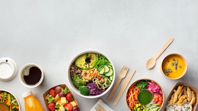 Healthy take away food and drinks in disposable eco friendly paper containers on gray background