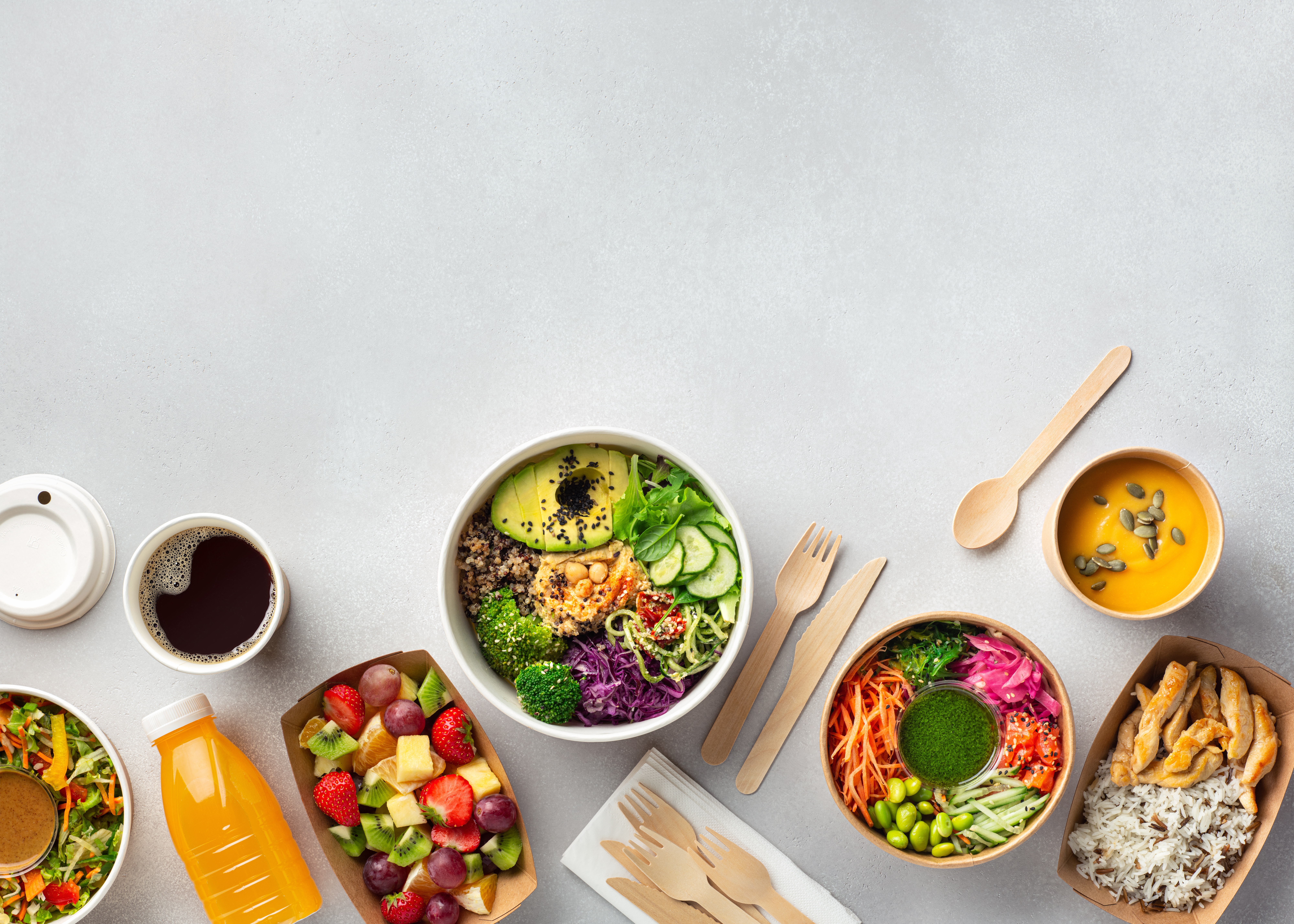 Healthy take away food and drinks in disposable eco friendly paper containers on gray background