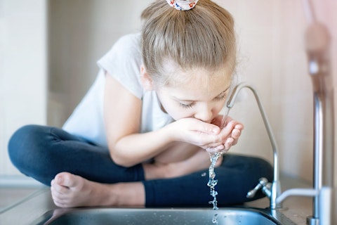 Little Girl Drinking from Water Tap