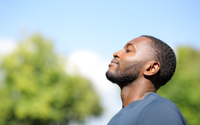 Man Breathing Fresh Air in Nature