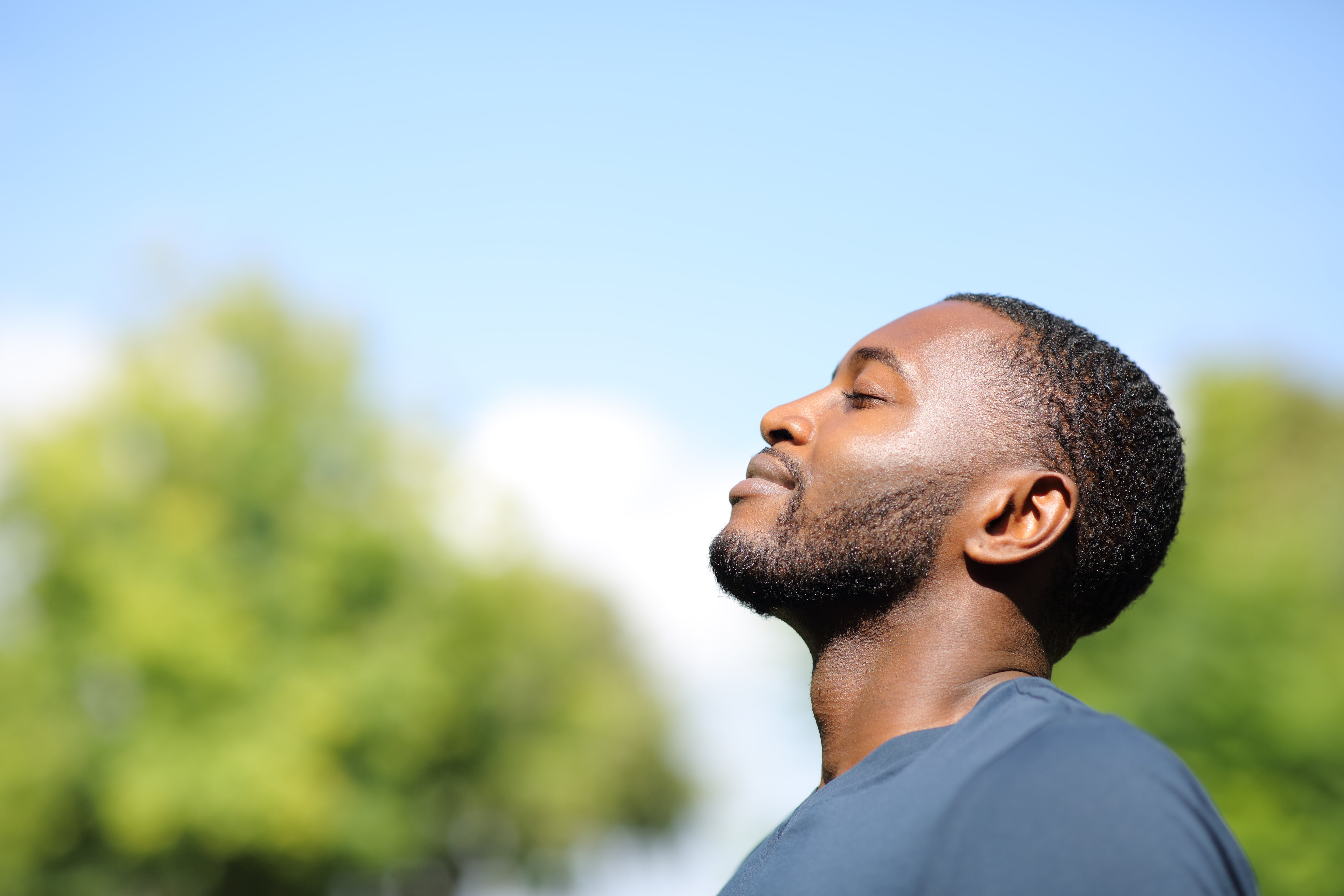 Man Breathing Fresh Air in Nature