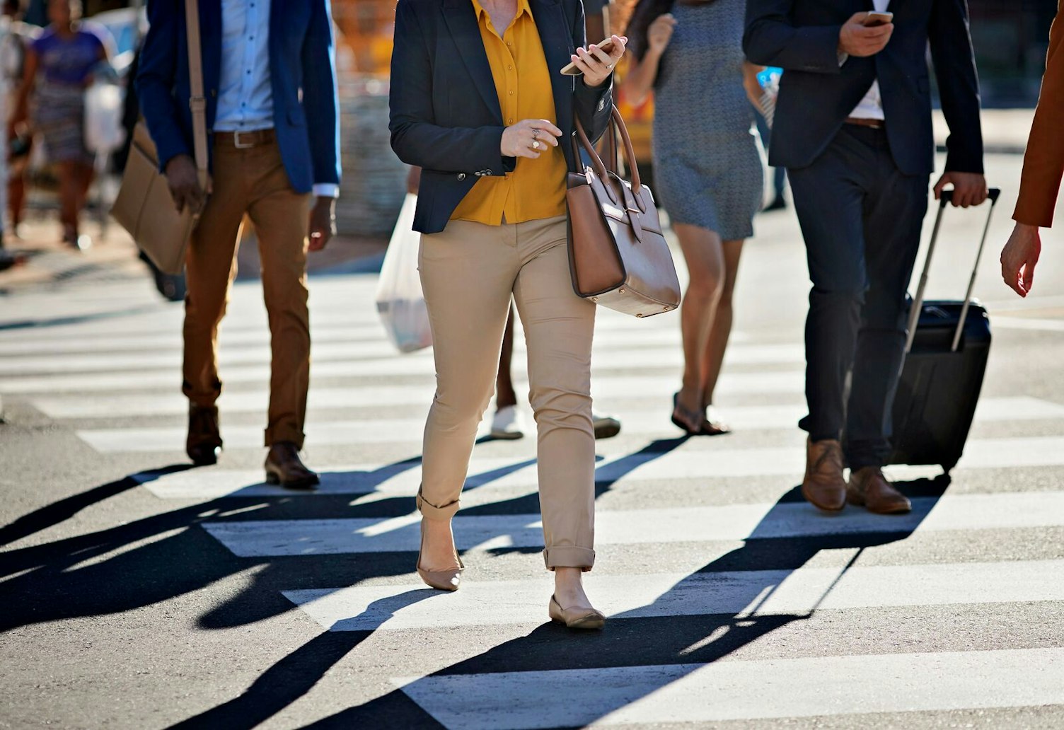 Mid Section of People Crossing the Street