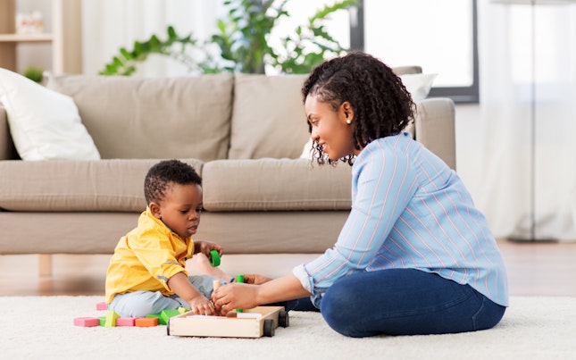 Mother and Son Playing with Wooden Toy Blocks