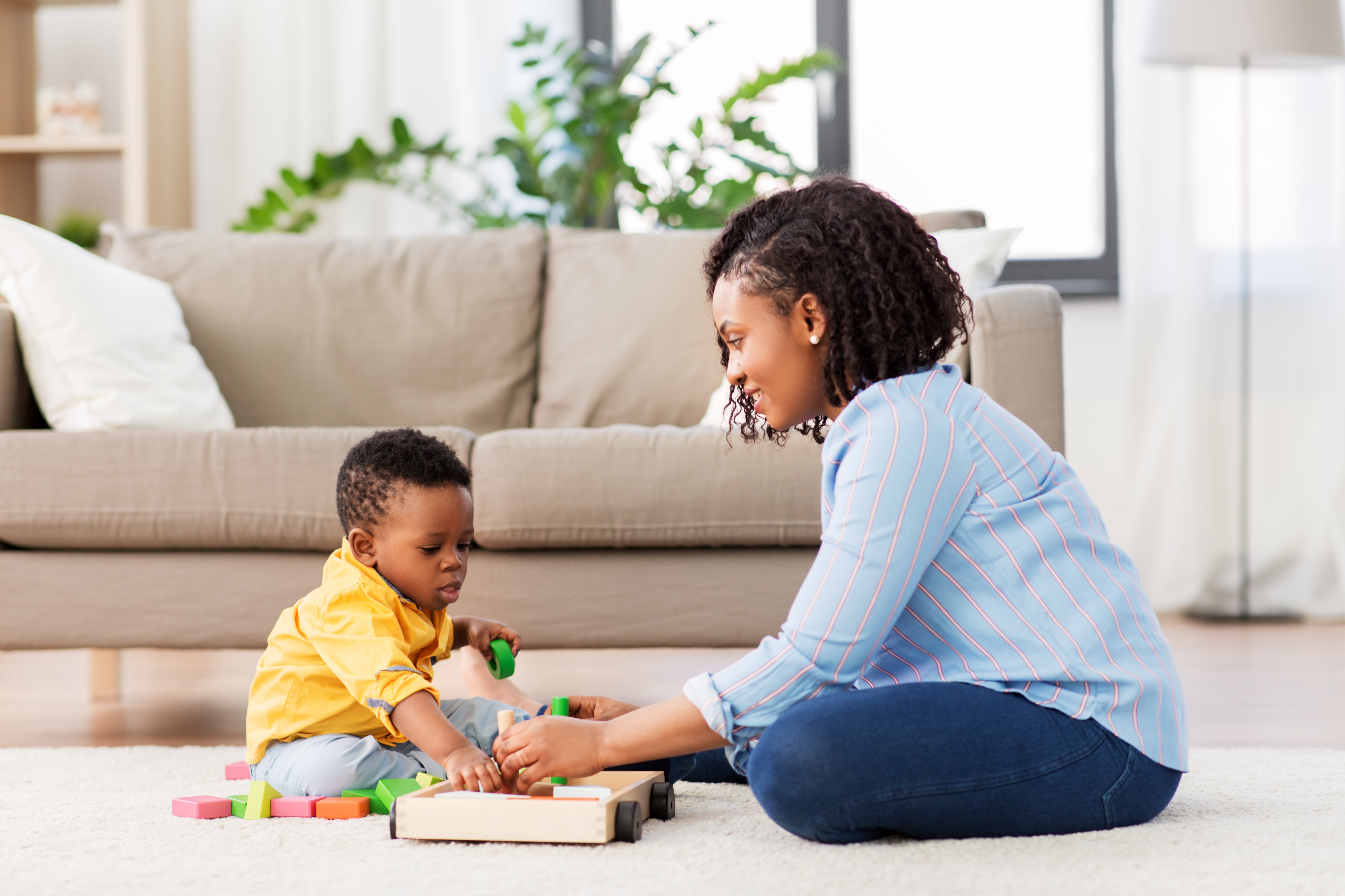Mother and Son Playing with Wooden Toy Blocks