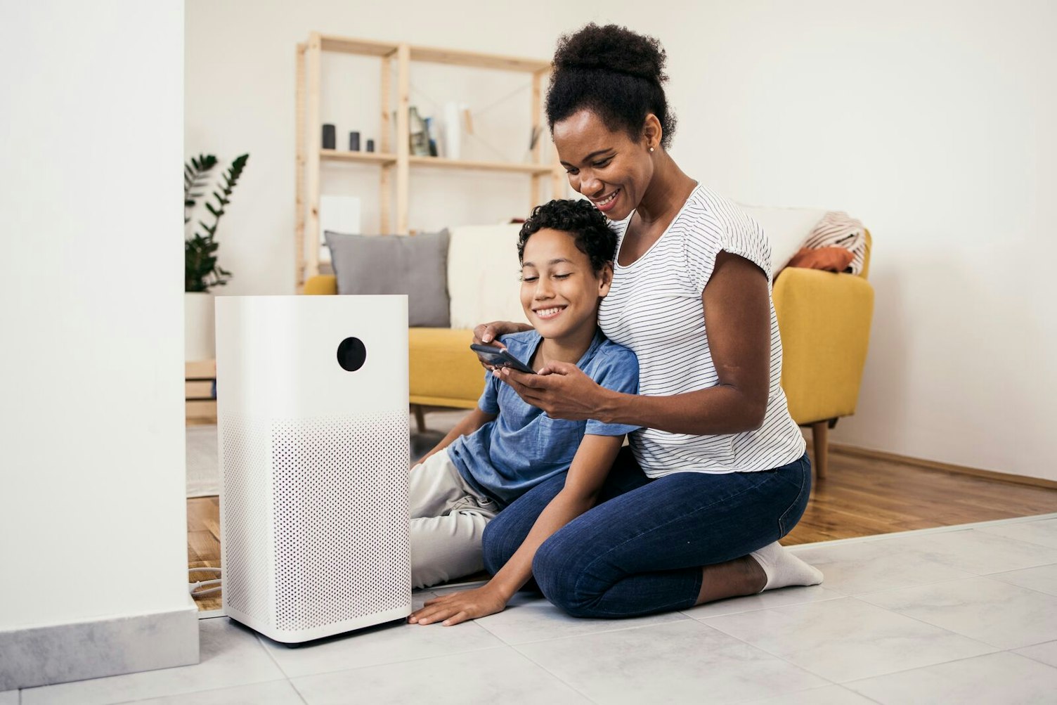 Mother and Son Setting up the Air Purifier System