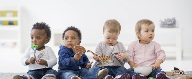 orig babies playing with toys indoors at a daycare Getty