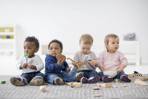 orig babies playing with toys indoors at a daycare Getty