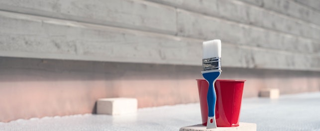 Paint brush and a bucket with paint