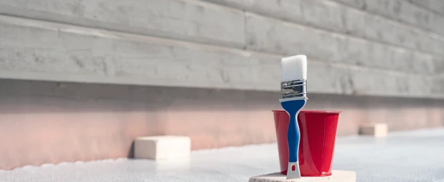 Paint brush and a bucket with paint