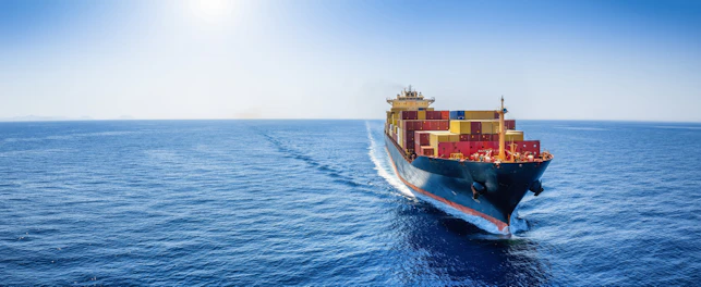 Panoramic front view of a cargo ship carrying containers