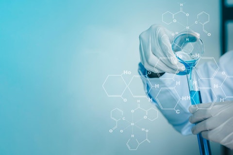 Scientist Pouring Test Tubes