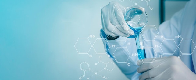 Scientist Pouring Test Tubes