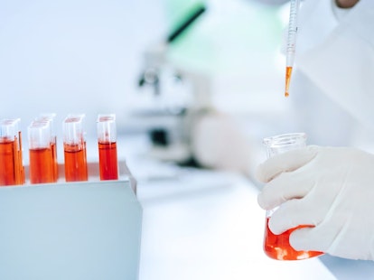 Scientist Testing Liquid Sample in Laboratory