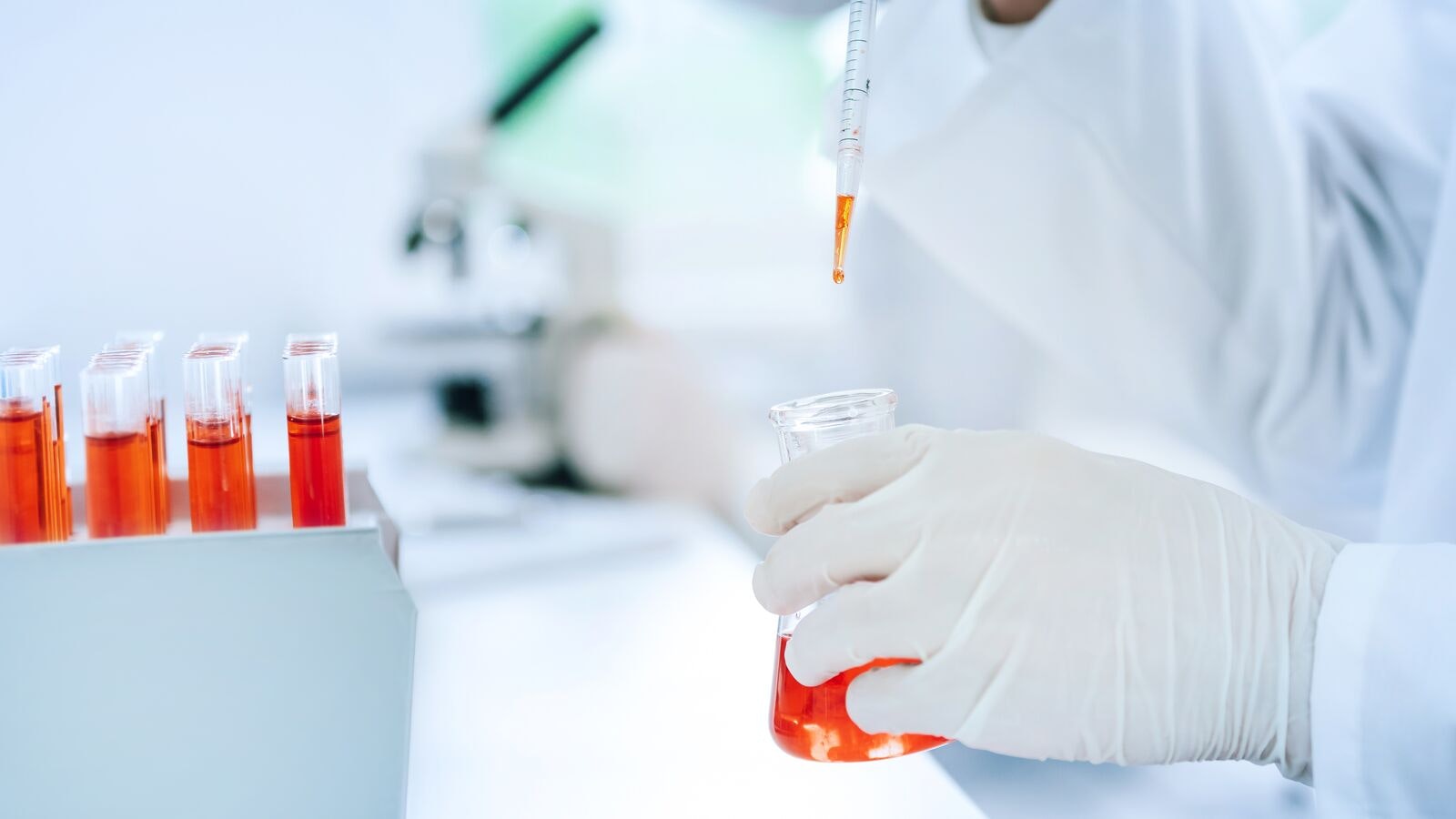 Scientist Testing Liquid Sample in Laboratory