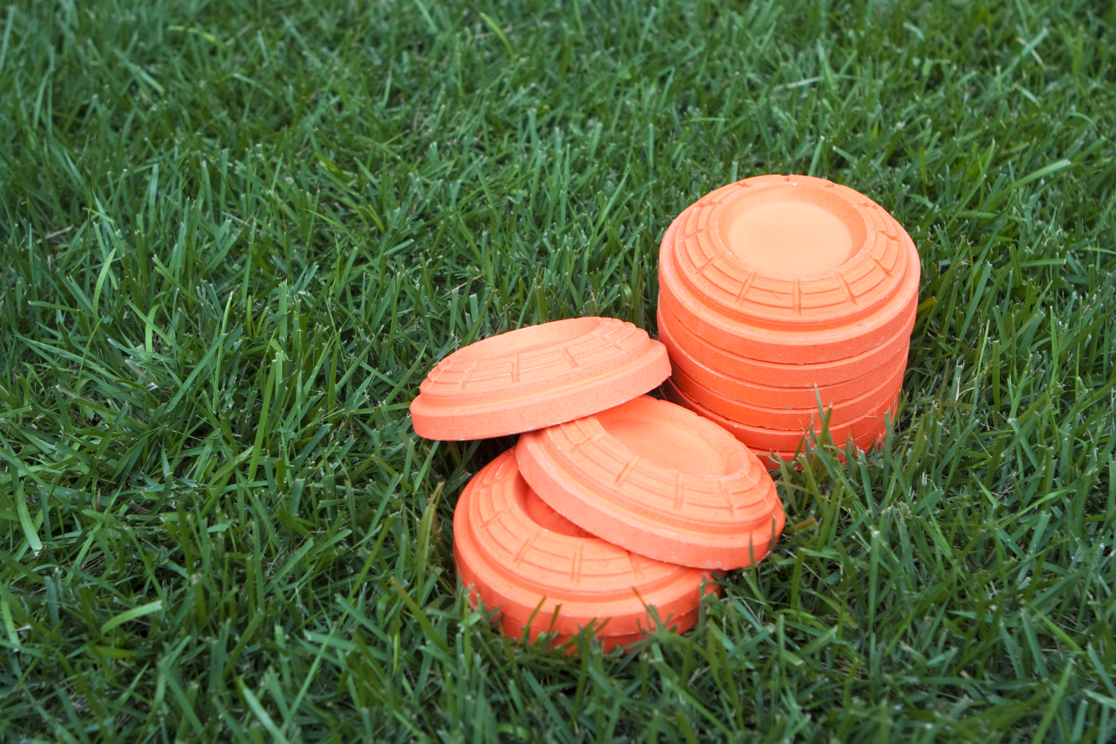 Stack of Unbroken Clay Pieces Laying on the Grass