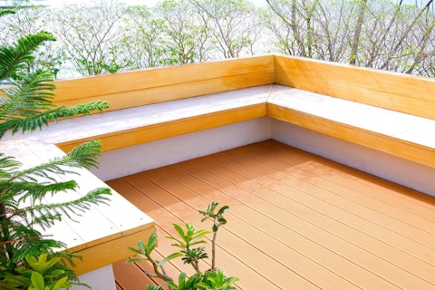 Terrace area of modern house with built in light wood bench
