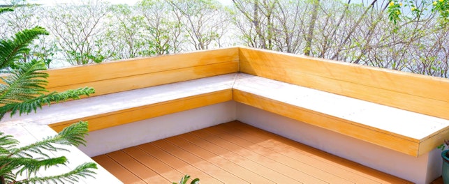 Terrace area of modern house with built in light wood bench