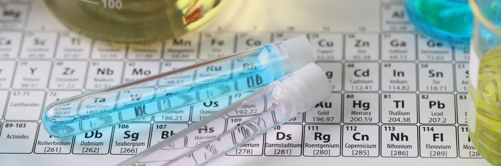 Top view of research laboratory glassware with liquids on periodic table