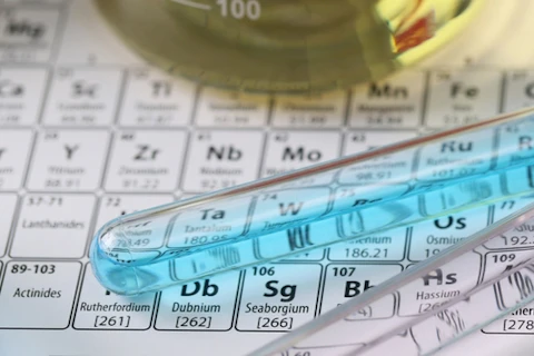 Top view of research laboratory glassware with liquids on periodic table