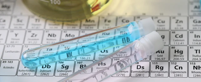 Top view of research laboratory glassware with liquids on periodic table
