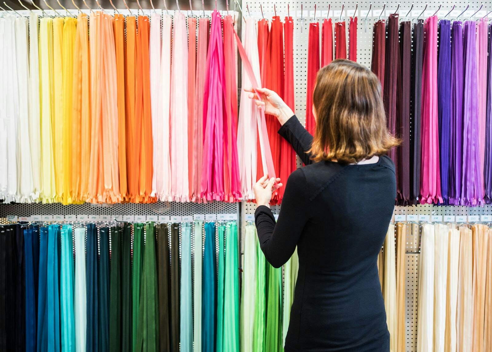 Woman Buying Colourful Zippers