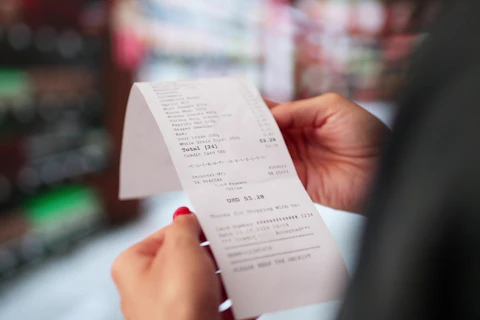 Woman Holding a Receipt