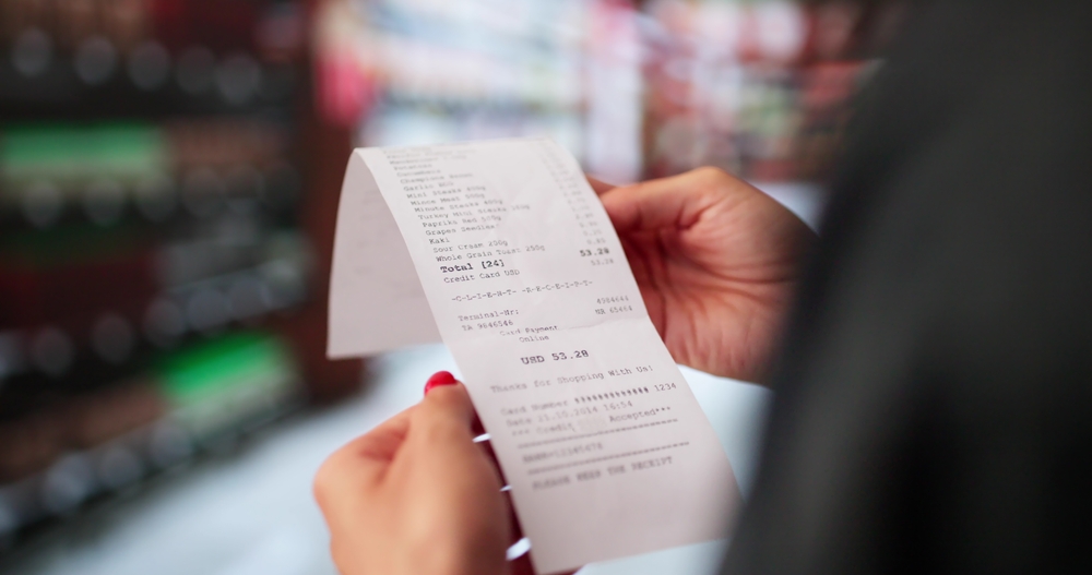Woman Holding a Receipt