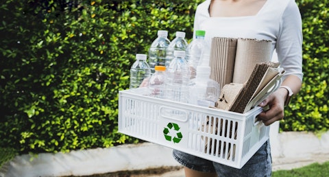 Woman Recycling Cardboard Boxes and Plastic Bottles