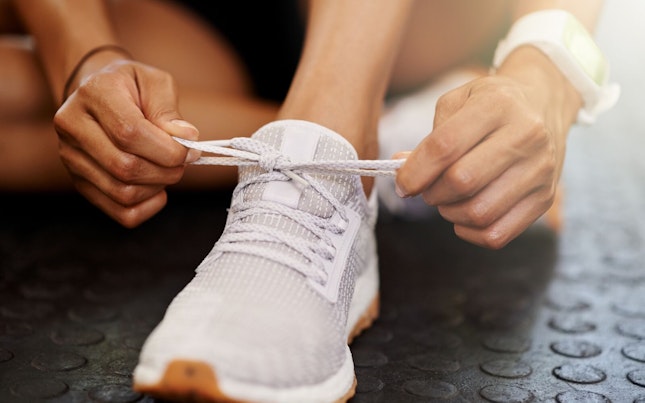 Woman Tying her Shoelaces