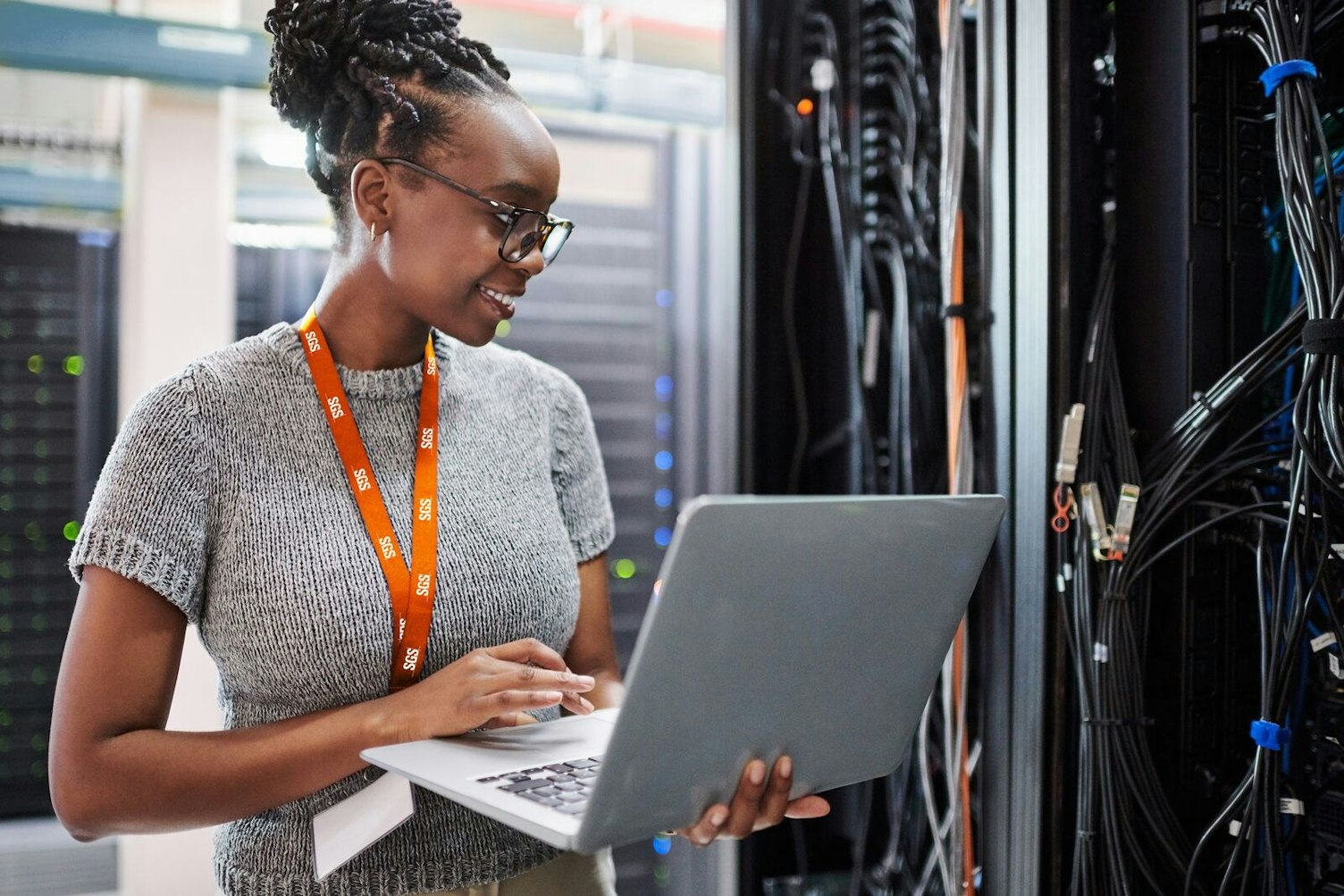 Woman Using a Laptop in a Server Room