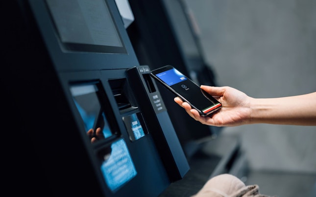 Woman Using Contactless Payment via Smartphone