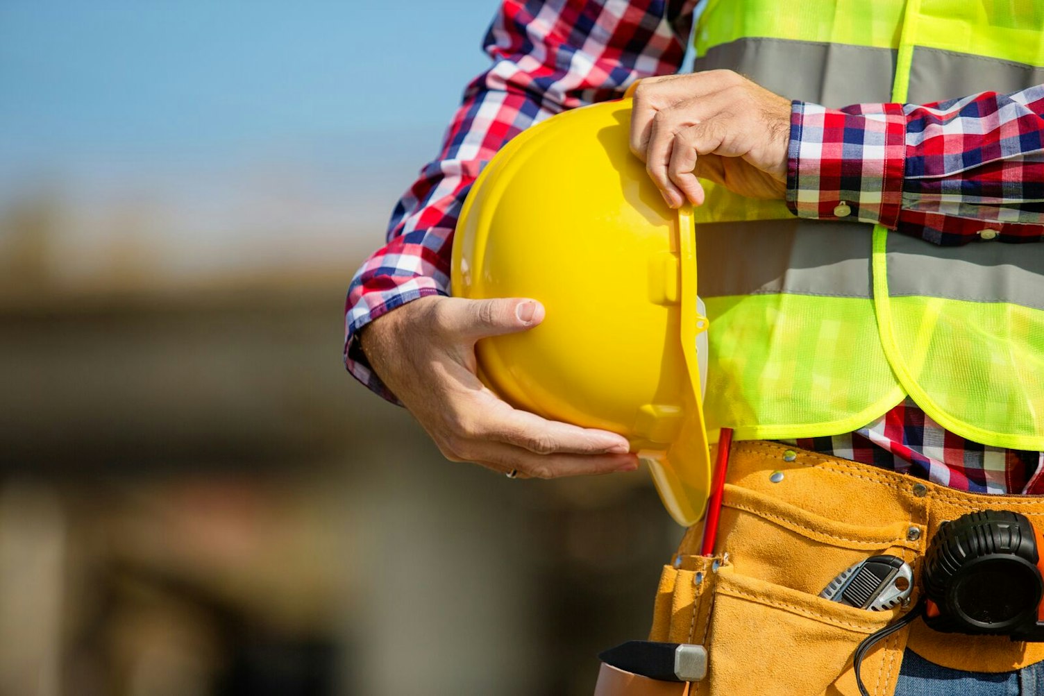 Worker Holding Helmet