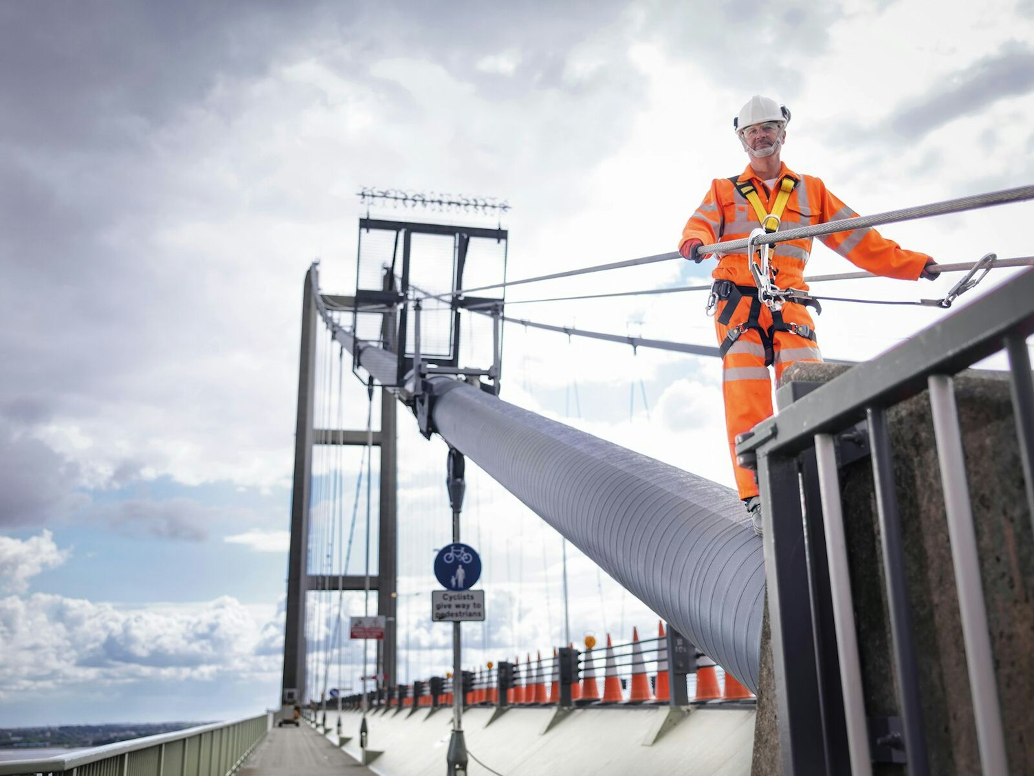 Worker on Suspension Bridge